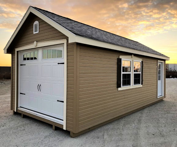 Chateau Series Garage with tan siding on gravel in front of a sunset.