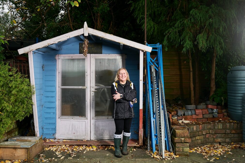 woman beside garden shed``woman beside garden shed