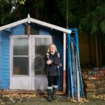 woman beside garden shed``woman beside garden shed